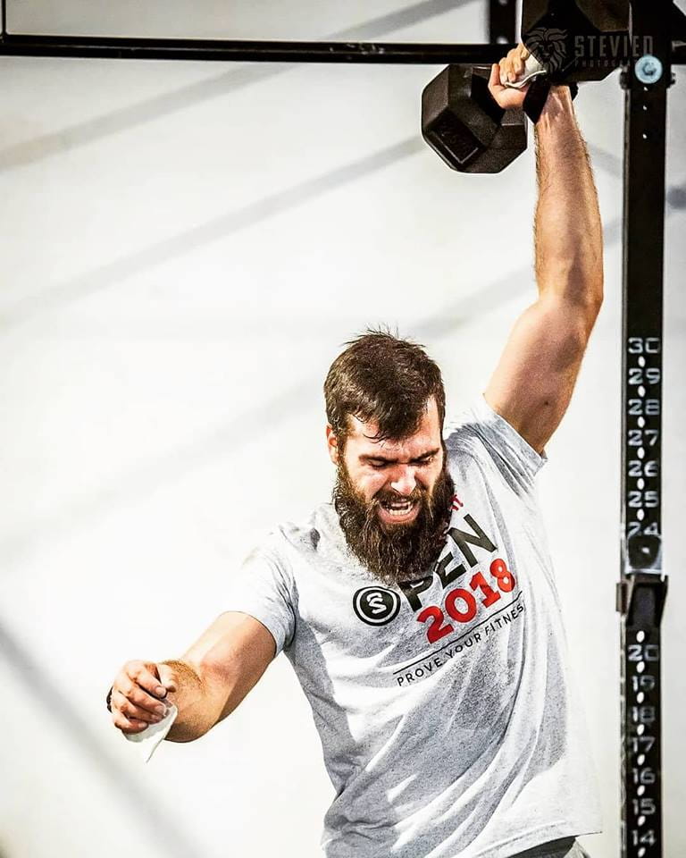 Athlete mid dumbbell snatch