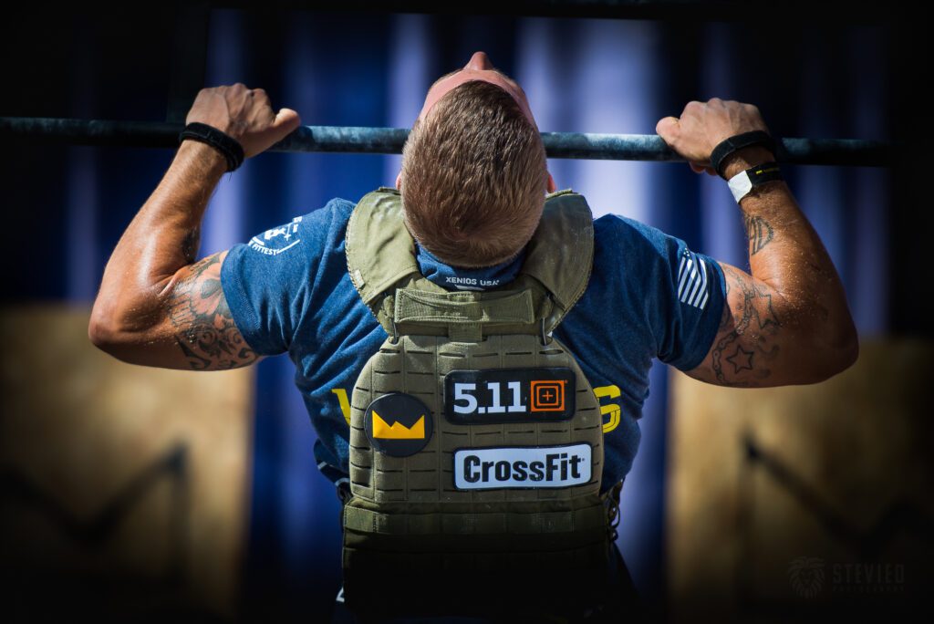 man performs crossfit pull-ups with weight vest Back Strength and Muscle Without Pull Ups