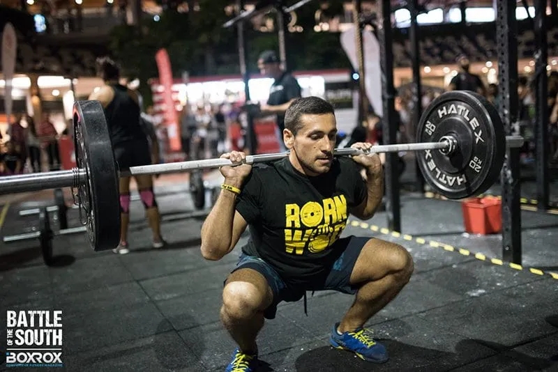 ectomorph male athlete squatting